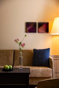 a vase with flowers on a table in a living room at Cresta Palace Celerina in Celerina