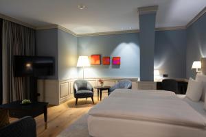 a hotel room with a bed and a tv at Cresta Palace Celerina in Celerina