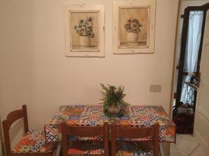 a dining room table with a plant on top of it at Casa Vacanze Keti in Viareggio