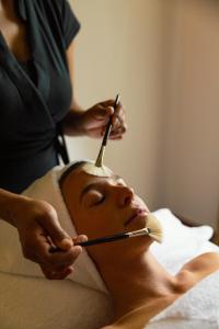 a woman getting a eyebrows cut with a brush at Cresta Palace Celerina in Celerina