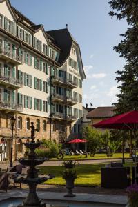 a fountain in front of a large building at Cresta Palace Celerina in Celerina