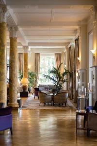 a large living room with chairs and a table at Cresta Palace Celerina in Celerina