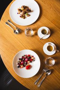 a table with plates of food and cups of coffee at Cresta Palace Celerina in Celerina