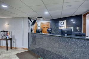 an office lobby with a reception counter with a desk at Quality Inn & Suites Downtown in Green Bay