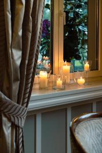a window with candles sitting on a window sill at Cresta Palace Celerina in Celerina