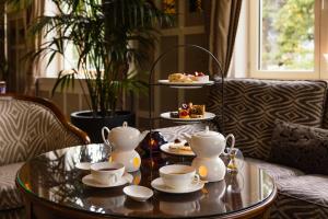 a table with cups and plates of food on it at Cresta Palace Celerina in Celerina