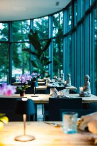 a restaurant with tables and chairs and windows at Cresta Palace Celerina in Celerina