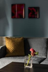 a vase with a flower sitting on a table at Cresta Palace Celerina in Celerina