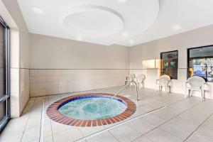 a hot tub in the middle of a room with chairs at Comfort Suites Murfreesboro in Murfreesboro