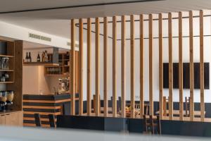 a staircase in a room with a bar at Hotel Garni Vinea Montis in Termeno