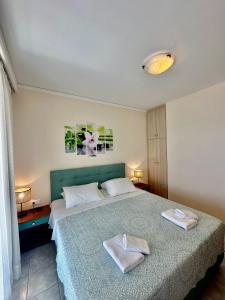 a bedroom with a bed with two towels on it at Lido Sofia Apartments in Agios Gordios