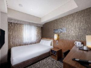 Postel nebo postele na pokoji v ubytování ibis Styles Tokyo Ginza