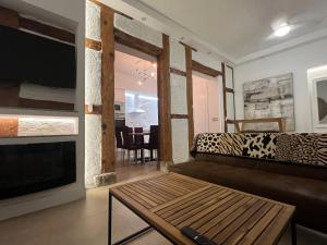 a living room with a couch and a television at Best loft luxury in Madrid center 12 in Madrid