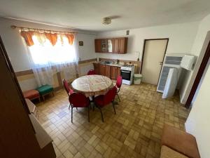a kitchen with a table and chairs in a room at Dom nad Solinką in Wołkowyja