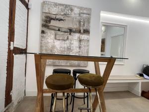 a bar in a room with stools and a mirror at Best loft luxury in Madrid center 12 in Madrid