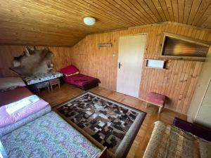 a room with a living room with a wooden ceiling at Dom nad Solinką in Wołkowyja