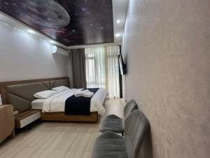 a bedroom with a bed and a view of the universe at Alley Palace ბათუმი in Angisa