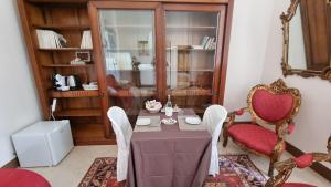 a dining room with a table and two chairs at Dimora San Leucio in Lecce +37 photos