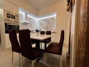 a kitchen with a dining room table and chairs at Best loft luxury in Madrid center 12 in Madrid +16 photos