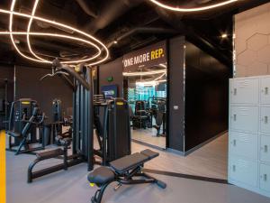 a gym with treadmills and machines in it at ibis Styles Manila Araneta City in Manila