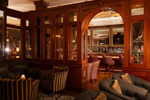 a room with a bar with couches at Manor House Country Hotel in Enniskillen