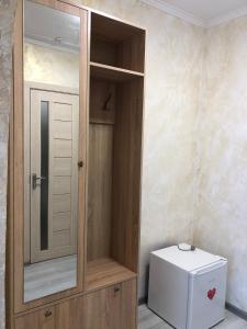 a wooden cabinet with a toilet in a bathroom at КП ДР Готель in Drohobytsch