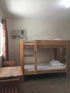 a bunk bed in a room with a microwave at Hotel Eight Fifty in Jagna