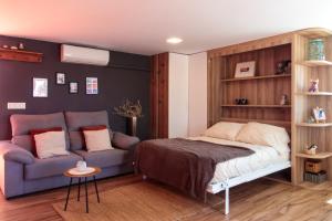 1 dormitorio con 1 cama y 1 sofá en Precioso ático en Valencia., en Valencia
