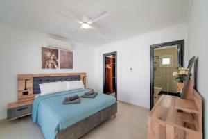a bedroom with a bed and a ceiling fan at Beautiful Puerto Del Carmen Villa 3 Bedrooms Villa Crystal Private Pool & Close To Amenities Lanzarote in Tías +33 photos