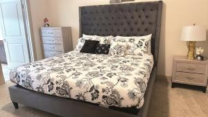 a bedroom with a bed with a black headboard at Domain at Kirby in Houston