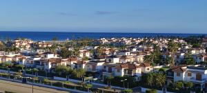a city with houses and the ocean in the background at Apartamento Domara Vera in Vera