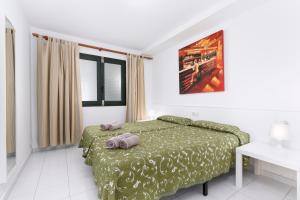 a bedroom with a bed with two pillows on it at Apartamentos Erika - Adults Only in Corralejo