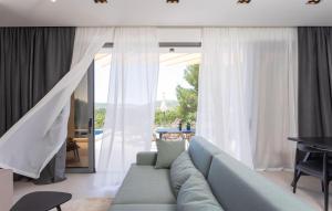 a living room with a couch and a large window at Gorgeous Home In Bilice With Wifi in Bilice