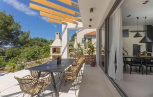 a patio with a table and chairs on a balcony at Gorgeous Home In Bilice With Wifi in Bilice +31 photos