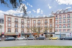 a large building with cars parked in front of it at PARIS CITY-Le Raincy - Facing station - 4 to 8 Pers in Le Raincy
