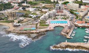an aerial view of a resort next to the ocean at Chalet at Aqualand Resort in Batroûn