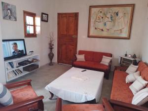 a living room with a couch and a table at Maison Bohème Suite Noura in Midoun