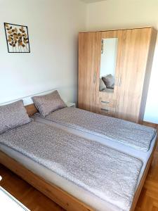 een bed met een houten hoofdeinde in een kamer bij LIMA in Subotica
