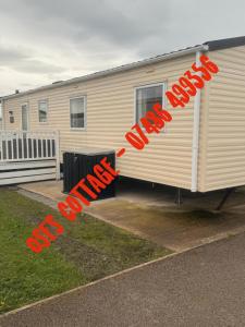 a mobile home with the words slow down written on it at Ose's Cottage in Banks