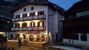 a large white building with lights in front of it at Cesa Do Ruf eurochalet in Campitello di Fassa