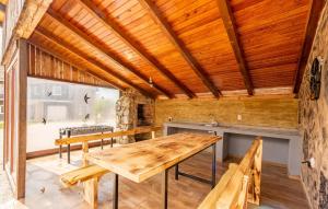Lovely Home In Gracac With Outdoor Swimming Pool في Gračac: غرفة طعام مع طاولة وكراسي خشبية