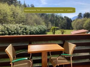 einen Tisch und Stühle auf einem Balkon mit Aussicht in der Unterkunft Country House Foglie d'erba in Calavino