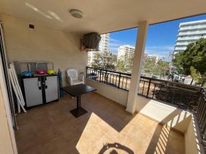 a balcony with a table and a view of the city at Apartamento Geminis I in Playa de Gandia