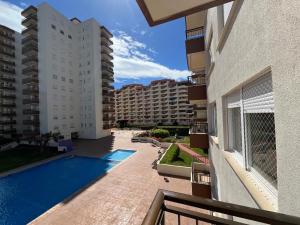 a view from the balcony of a building with a swimming pool at Apartamento Geminis I in Playa de Gandia