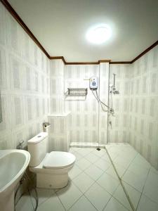 La salle de bains est pourvue de toilettes et d'un lavabo. dans l'établissement Heuang Paseuth Hotel 香帕赛酒店, à Luang Prabang