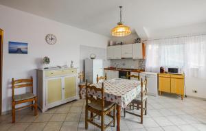 Il dispose d'une cuisine avec une table et des chaises. dans l'établissement 3 Bedroom Amazing Apartment In Imperia, à Imperia