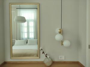 a mirror in a white room with a bed at Villa Kalliopi in Chania Town