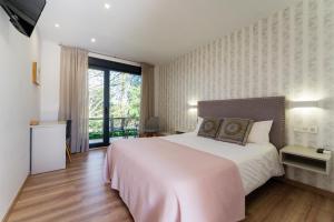 Postel nebo postele na pokoji v ubytování Hotel A Curuxa Wellness