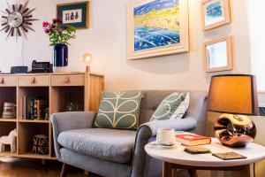 a living room with a couch and a table at Round House East in Veryan