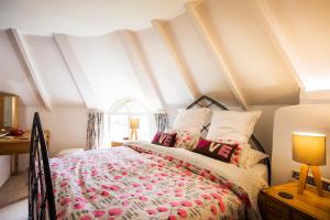 a bedroom with a bed and a window at Round House East in Veryan
